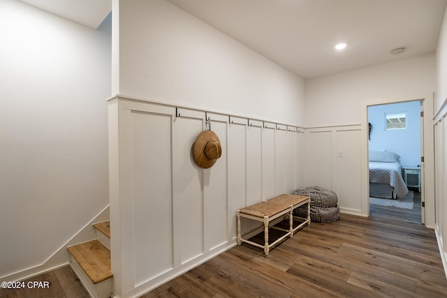 mudroom featuring recessed lighting, wainscoting, a decorative wall, and wood finished floors