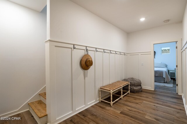 mudroom featuring recessed lighting, wainscoting, a decorative wall, and wood finished floors