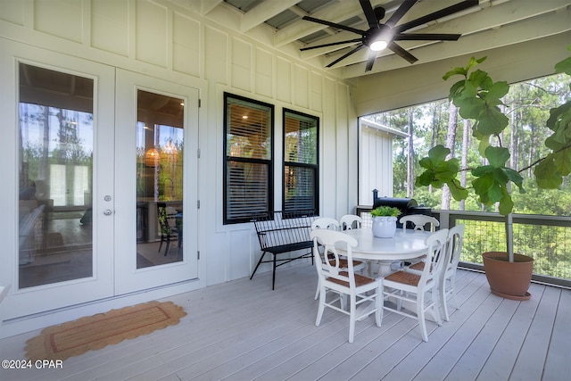 sunroom / solarium featuring a wealth of natural light, beam ceiling, and a ceiling fan