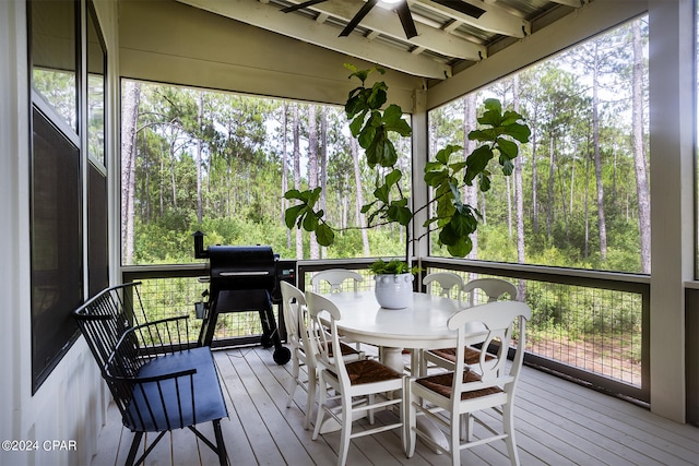 sunroom / solarium featuring a healthy amount of sunlight and ceiling fan