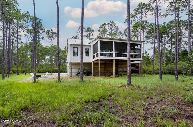 rear view of property featuring stairs and a sunroom