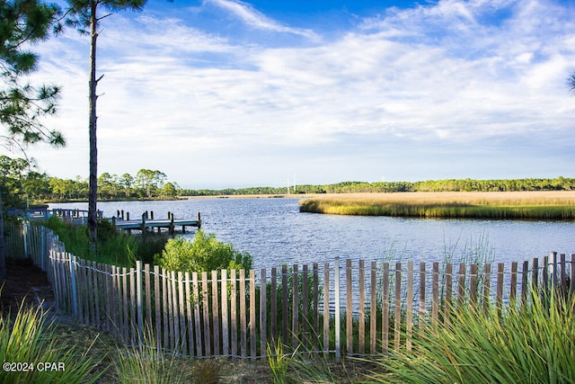 water view with fence and a boat dock