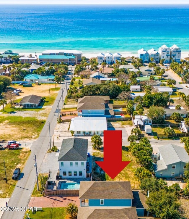 drone / aerial view featuring a water view and a residential view