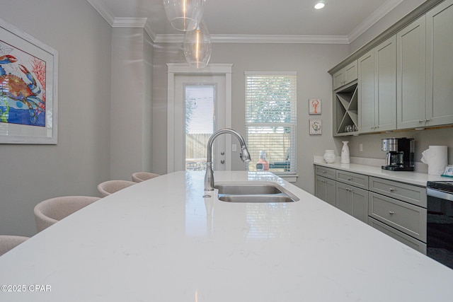 kitchen with gray cabinets, a sink, and crown molding