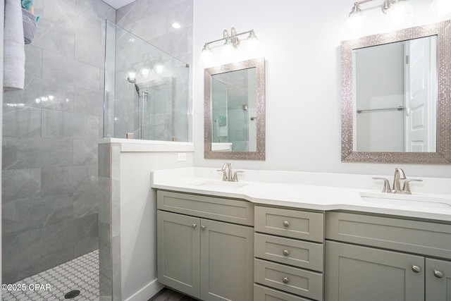 full bathroom featuring double vanity, a walk in shower, and a sink