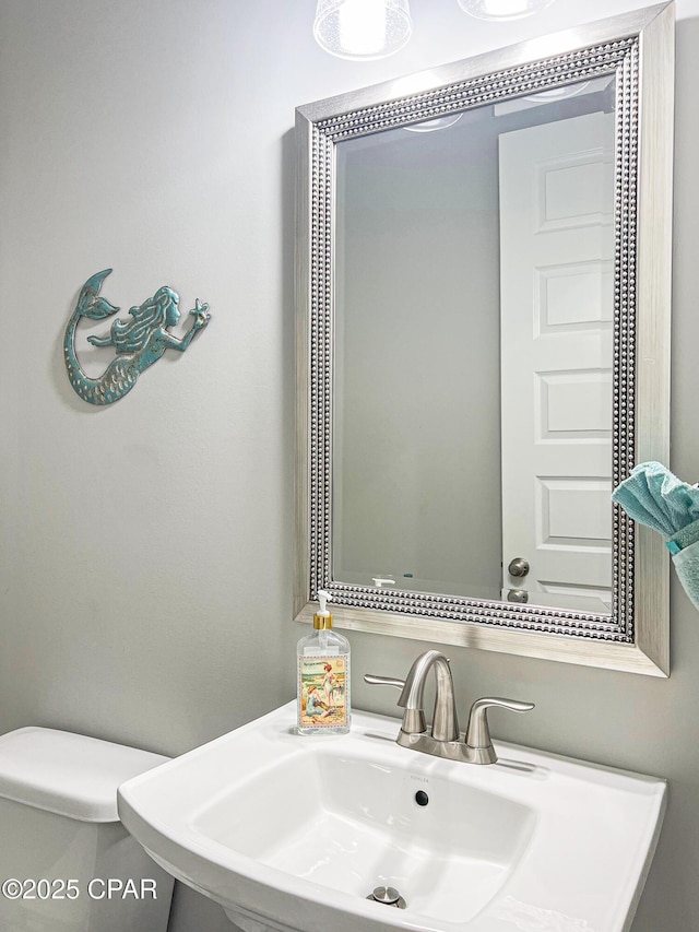 bathroom featuring toilet and a sink