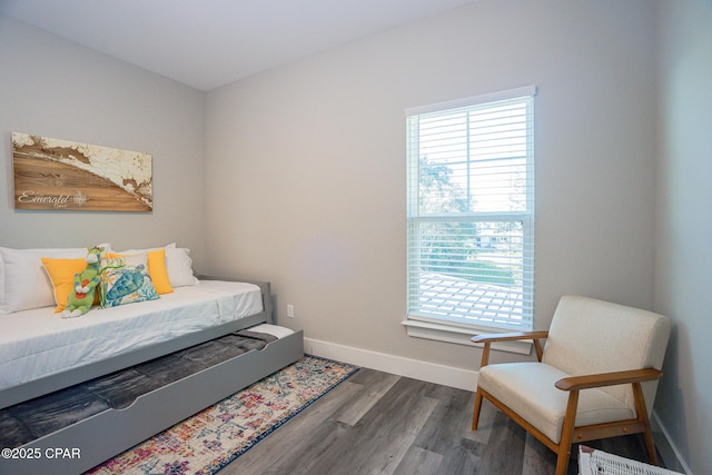 bedroom featuring baseboards and wood finished floors