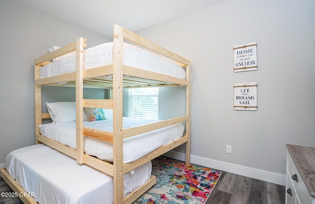 bedroom with baseboards and wood finished floors