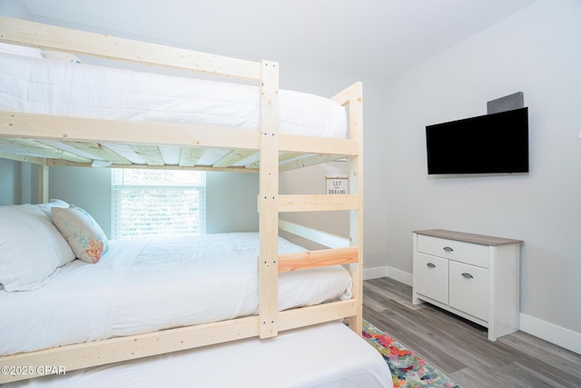 bedroom with baseboards and light wood finished floors