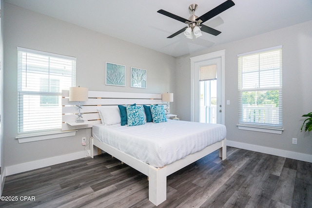 bedroom with a ceiling fan, baseboards, and dark wood-type flooring