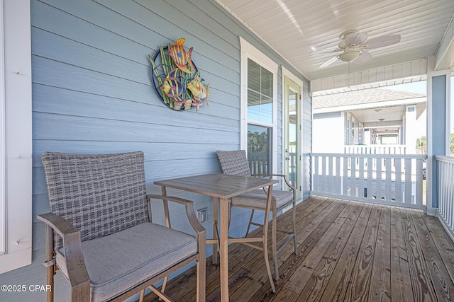 wooden deck featuring a ceiling fan and covered porch