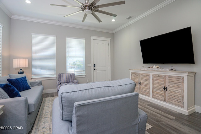 living room with baseboards, ceiling fan, wood finished floors, and crown molding