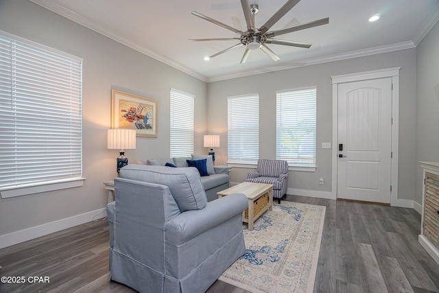 living area with baseboards, dark wood finished floors, and crown molding