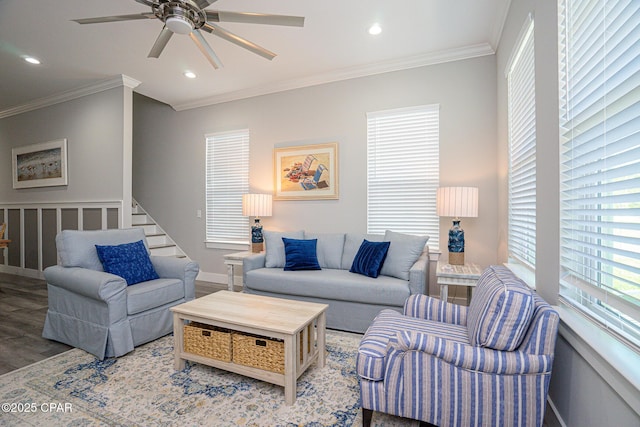 living room with recessed lighting, wood finished floors, a ceiling fan, stairs, and crown molding