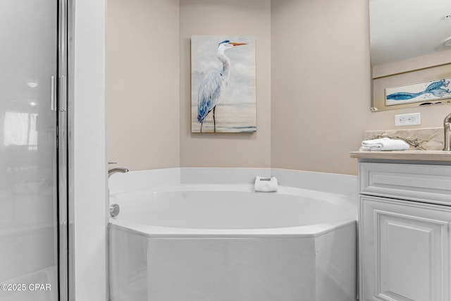bathroom featuring vanity and a tub