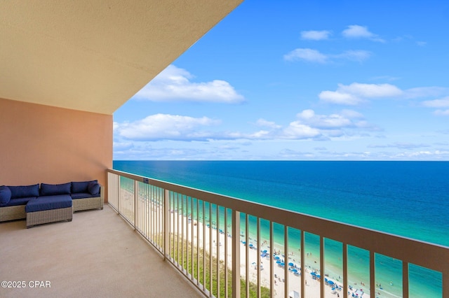 balcony featuring a water view, a beach view, and an outdoor hangout area