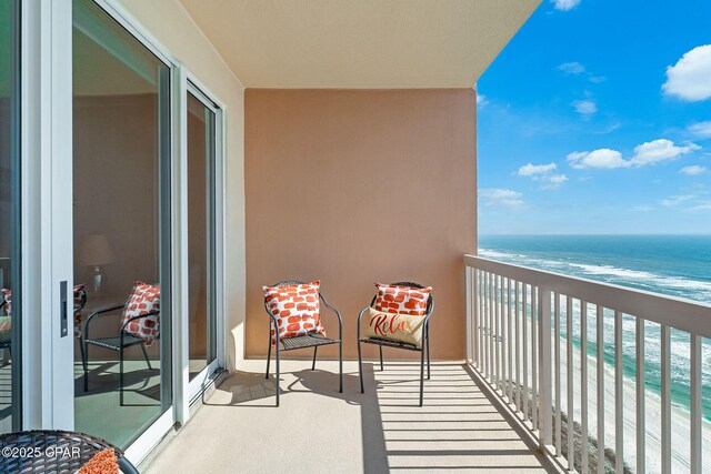 balcony with a beach view and a water view