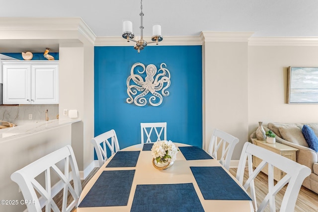dining room with crown molding, wood-type flooring, and a notable chandelier