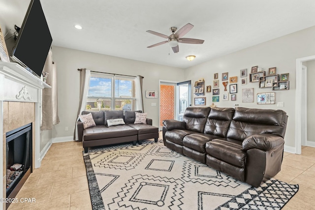 living room with ceiling fan, light tile patterned floors, and a fireplace