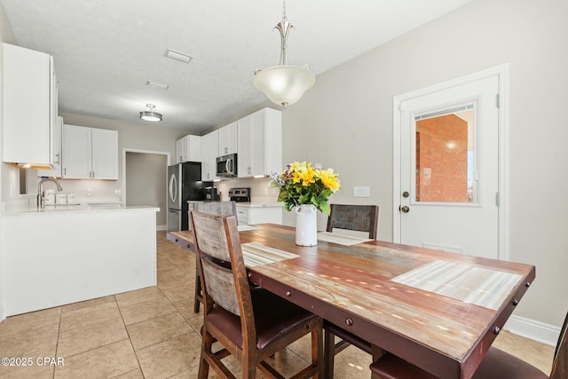 tiled dining area featuring sink