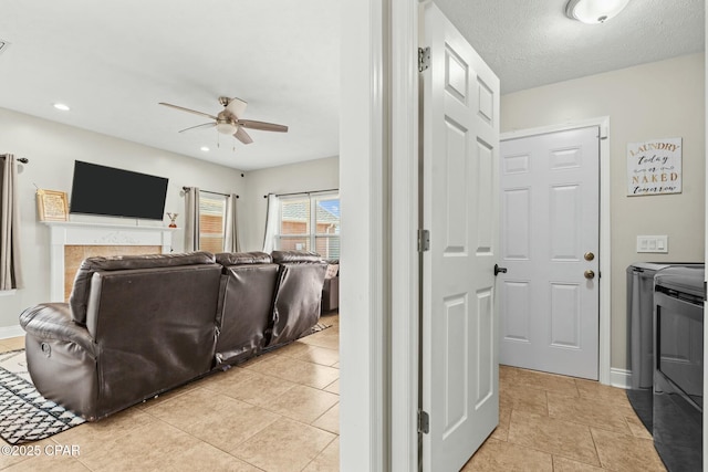 interior space featuring a textured ceiling, washer and dryer, and ceiling fan