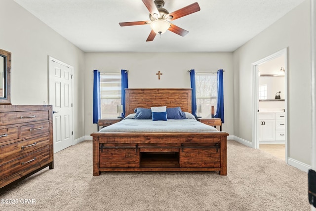 carpeted bedroom with ceiling fan and ensuite bath