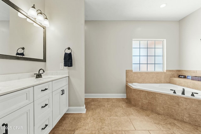 bathroom with vanity, tiled tub, and tile patterned floors