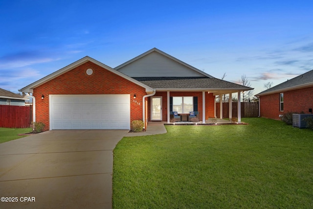 view of front of property with a garage, a porch, a yard, and central air condition unit