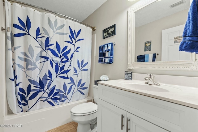 full bathroom featuring toilet, a textured ceiling, vanity, shower / bath combo with shower curtain, and tile patterned flooring