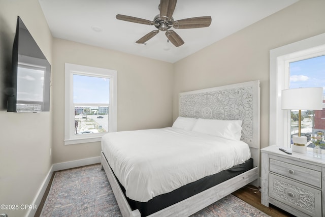 bedroom with ceiling fan and dark hardwood / wood-style flooring