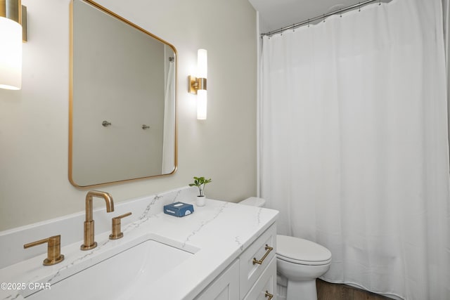 bathroom with vanity, hardwood / wood-style floors, and toilet