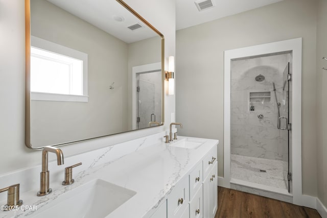 bathroom featuring a shower with door, wood-type flooring, and vanity