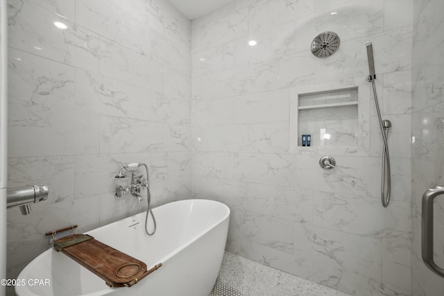 bathroom featuring shower with separate bathtub and tile walls