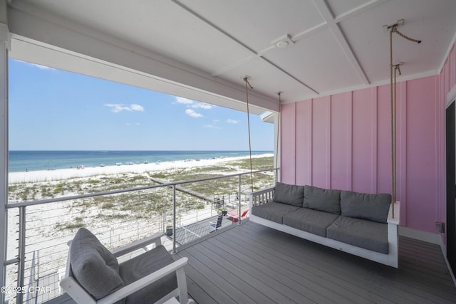 deck with a water view and a beach view