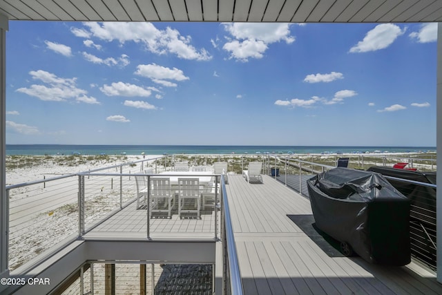 wooden terrace with a water view and a beach view