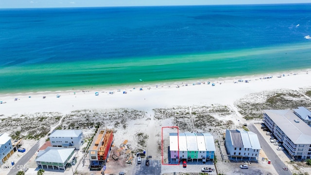 birds eye view of property with a beach view and a water view