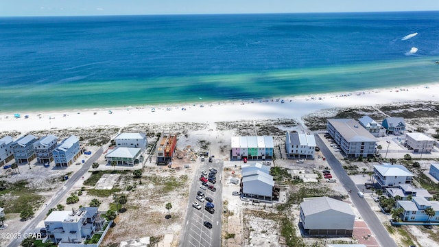 birds eye view of property with a water view and a view of the beach