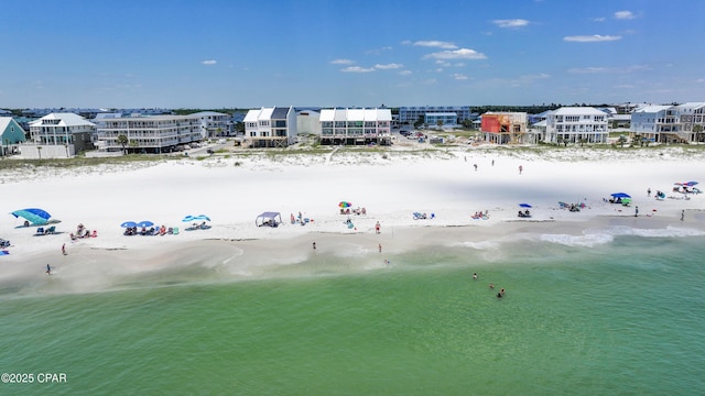 birds eye view of property featuring a beach view and a water view