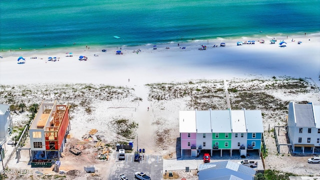 drone / aerial view featuring a water view and a beach view