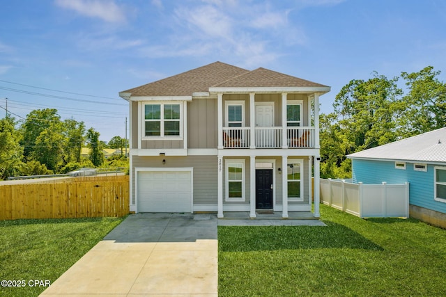 view of front of property featuring driveway, roof with shingles, fence, a front lawn, and board and batten siding