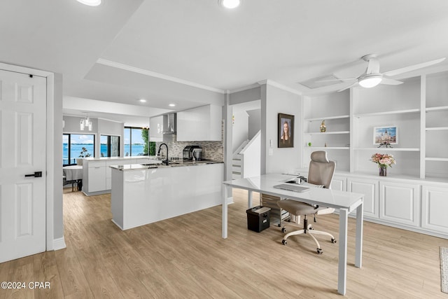 home office featuring ceiling fan, crown molding, sink, and light hardwood / wood-style floors