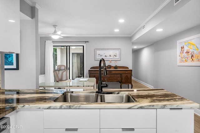 kitchen with sink, light hardwood / wood-style flooring, ornamental molding, ceiling fan, and white cabinets