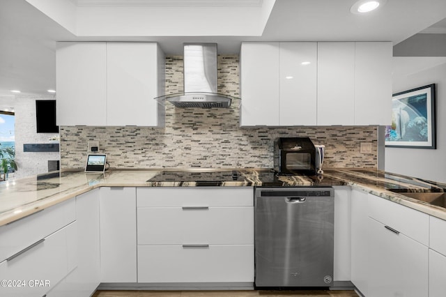 kitchen featuring white cabinets, dark stone counters, stainless steel dishwasher, wall chimney range hood, and black electric cooktop