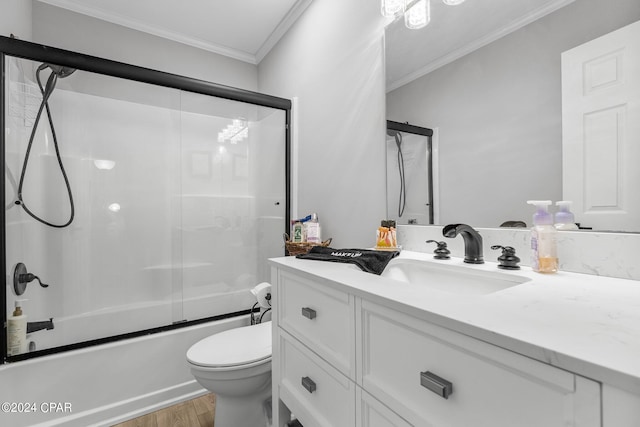 full bathroom featuring toilet, ornamental molding, vanity, enclosed tub / shower combo, and hardwood / wood-style floors