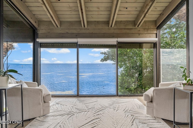 sunroom / solarium with beam ceiling, wooden ceiling, and a water view