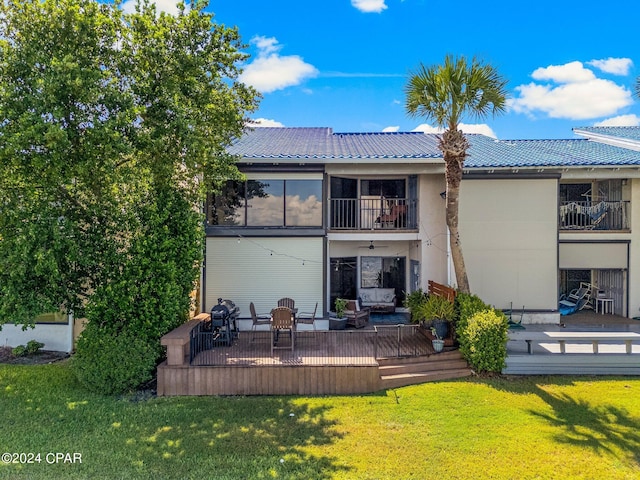 back of property featuring a yard, outdoor lounge area, and a balcony