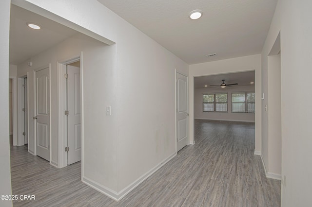 corridor with light hardwood / wood-style flooring