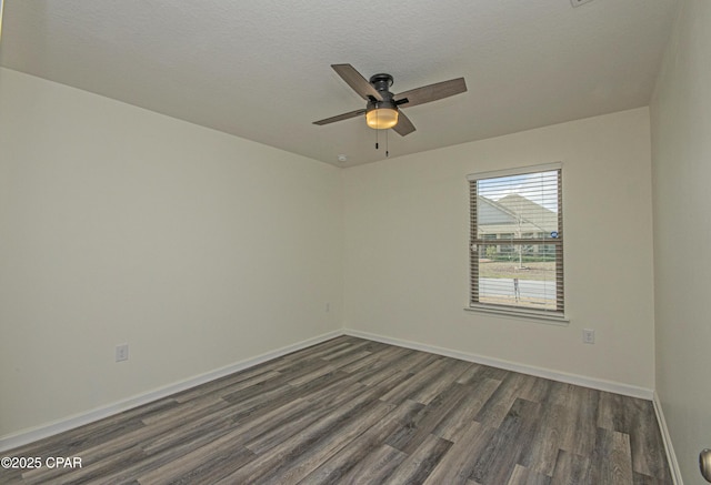 unfurnished room featuring dark hardwood / wood-style flooring, ceiling fan, and a textured ceiling