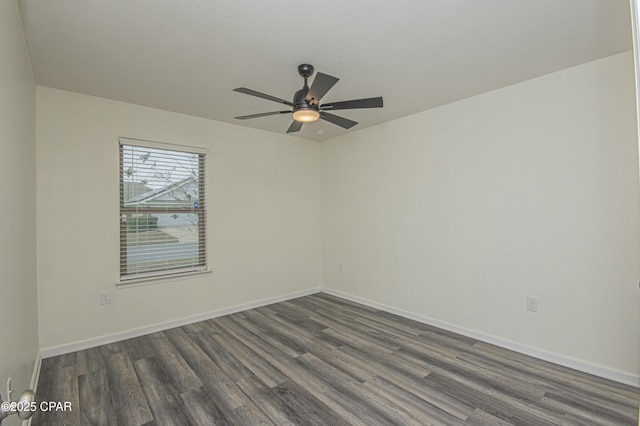 unfurnished room featuring dark wood-type flooring and ceiling fan