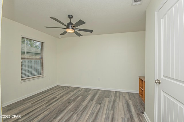 spare room with ceiling fan, hardwood / wood-style floors, and a textured ceiling